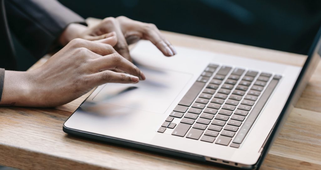 Close up Typing on a laptop brand management